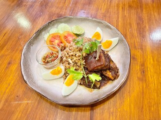 Thai spicy shrimp paste fried rice served with braised belly pork and boiled eggs