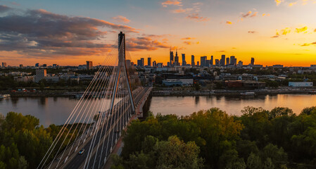 Warsaw city center and skyscrapers in the background Vistula river and Swietokrzyski bridge. Sunset  Warsaw aerial view.