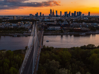 Warsaw city center and skyscrapers in the background Vistula river and Swietokrzyski bridge. Sunset  Warsaw aerial view.