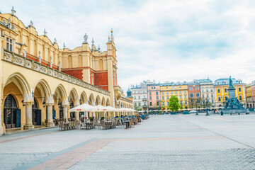 Obraz premium Main street Rynek Głowny in Krakow with square and church St. Mary's Basilica in Poland