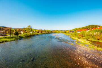 Peak Tri Koruny or Trzy Korony during day with green meadow and trees in spring. Pieniny National...