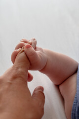 mum and baby holding hands. bonding and care concepts