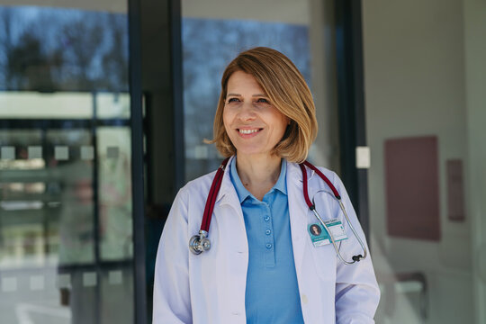Portrait of female doctor in uniform, smiling. - Powered by Adobe