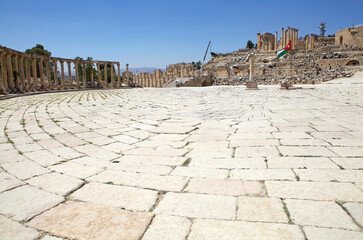 The ancient city of Gerasa, now Jerash, Jordan. The original flooring and Jordanian flag at the...
