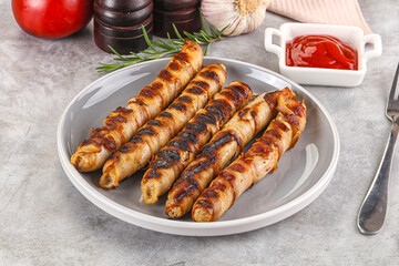Grilled meat sausages wrapped bacon