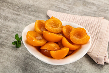 Sweet canned apricots with syrope