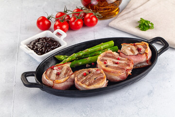 Tasty grilled pork medallion with bacon
