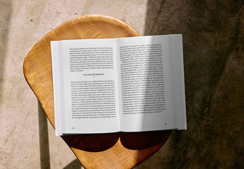 Mockup Of Customized Hardback Book Open On Stool