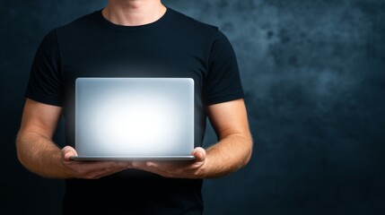 Person holding a laptop with a bright screen, showcasing modern digital technology.