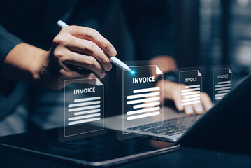 Digital Invoice Management: A hand uses a stylus to interact with glowing virtual invoices on a...