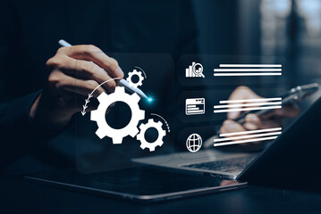 Business Process Automation: Hands using a stylus on a tablet, interacting with virtual gears, lock, chart, and other process icons, symbolizing workflow efficiency and technological solutions.