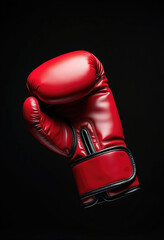 Red Boxing Glove in Spotlight Against Black Background for Sports Gear Advertising, Fitness Motivation, and Combat-Themed Visuals
