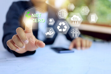 Net zero carbon dioxide emission concept with businessman pointing on policy icon to encourage company organization to implement and action compliance requirement for save the world environment