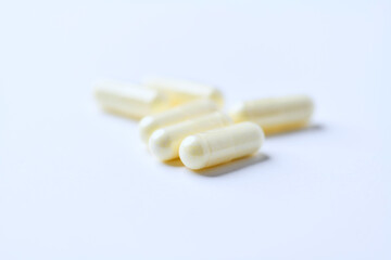 Alpha-lipoic acid capsules. Paper background. Soft focus. Close up. Copy space.