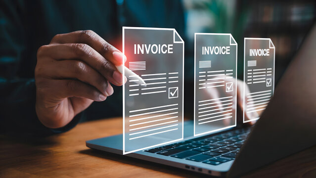A person uses a stylus to review digital invoices on a laptop showcasing modern accounting software and efficient online billing management for business.