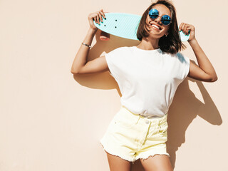 Young beautiful sexy smiling hipster woman in sunglasses.Trendy female in summer T-shirt and...
