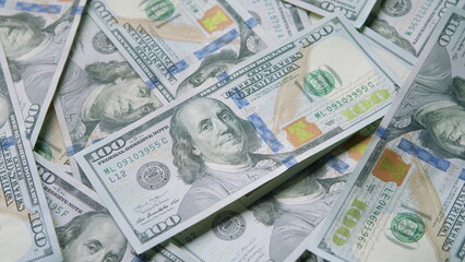 A large stack of hundred dollar bills represents financial abundance and significant wealth