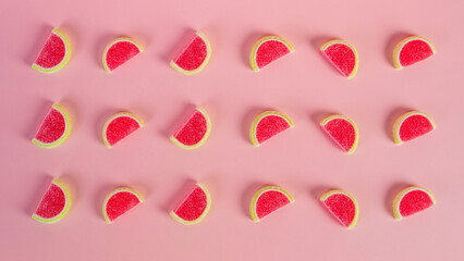 Fruit jelly mixed with sugar on pink background