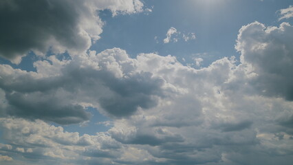 A stunning display of dynamic cloud patterns gracefully drifting under the bright blue sky Time...