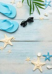 Summer beach essentials on wooden background