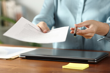 Office worker giving you contract to sign and pen