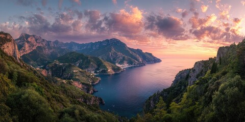 Panoramic sunset view of a coastal mountain range, with a calm sea, lush vegetation and vibrant, colorful sky