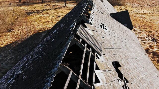 Crumbling Soviet era farm rooftop, slow motion, early spring in rural Latvia, 4K