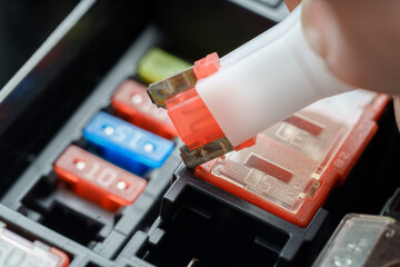 Hand Removing Blown Automotive Fuse