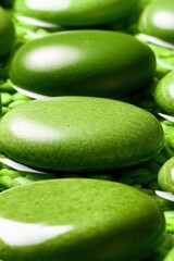 Close-up macro of glossy green stones arranged in layers with a smooth surface texture and soft reflections