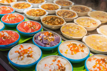 Many small bowls of Chinese food in the food court