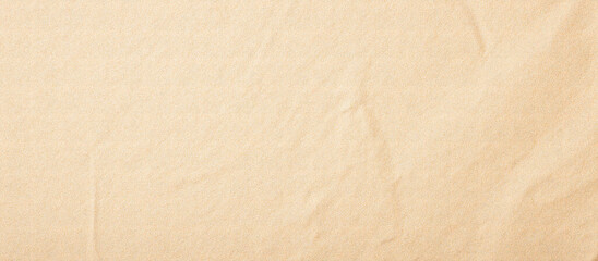 Beige craft paper texture with wrinkles and fine grain. Natural recycled paper background for design, art, and eco concepts