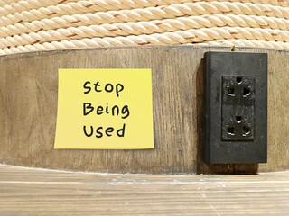 Yellow note with text written Stop Being Used - Self reminder to avoid getting used by people who take advantage of you
