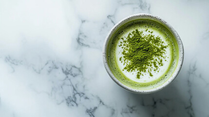 Minimal Flatlay of Matcha Latte with Green Powder on a Polished Marble Surface in Soft Natural Lighting