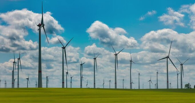 Time-lapse footage of modern wind turbines spinning over vibrant green fields in rural Germany. A powerful symbol of the Energiewende and Germany&rsquo;s response to climate change and energy transition