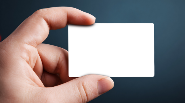   Close-up of a hand gripping an empty white paper card on clear PNG background. 