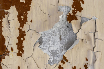 Peeling paint on the wall. Old concrete wall with cracked flaking paint. Weathered rough painted...