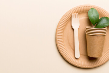 set of empty reusable disposable eco-friendly plates, cups, utensils on light white colored table background. top view. Biodegradable craft dishes. Recycling concept. Close-up