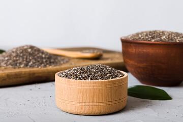 Chia seeds in bowl and spoon on colored background. Healthy Salvia hispanica in small bowl. Healthy...