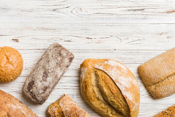 Homemade natural breads. Different kinds of fresh bread as background, top view with copy space