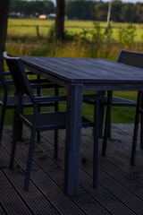 table and chairs standing on a lawn at the garden. High quality photo