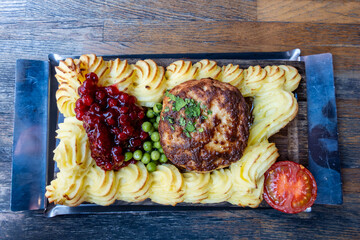 Stockholm, Sweden A  traditional dish of hashed beef with mashed potatoes on a wooden platter,...