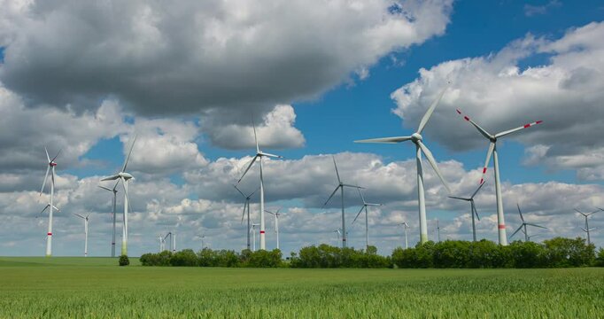Time-lapse footage of modern wind turbines spinning over vibrant green fields in rural Germany. A powerful symbol of the Energiewende and Germany&rsquo;s response to climate change and energy transition
