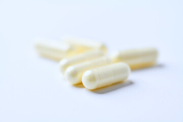 Alpha-lipoic acid capsules. Paper background. Soft focus. Close up. Copy space.	