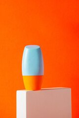 Blank tube with cosmetic product for moisturizing on orange background
