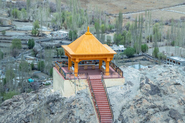 Obraz premium Far view of meditation space at Diskit Monastery with majestic Himalayan mountains in the backdrop. Serene landscape blending spirituality, culture, and nature, ideal for travel and creative projects