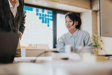 Co-workers brainstorming together in a modern, rustic office setting with a creative atmosphere.