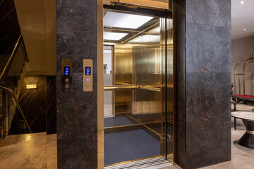 Golden shiny  hotel elevator interior