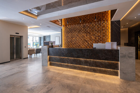 Modern hotel reception with wooden wall