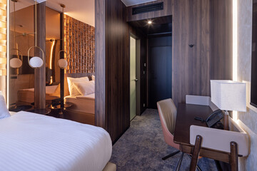 Interior of a hotel room with work desk area