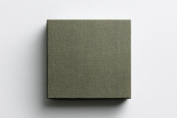 A square, muted olive-green fabric-covered box sits on a stark white background; simple, understated elegance